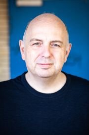 Portrait von Frank Goosen vor blauem Hintergrund